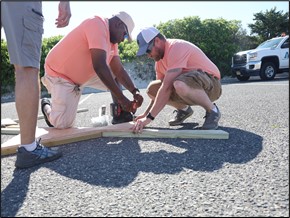 Employees build a lifeguard chair.