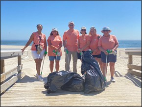 Employee volunteers clean beach.