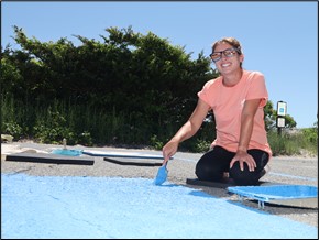 Employees paint parking spaces.