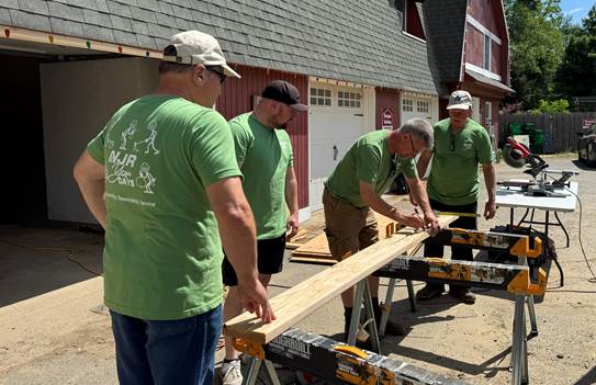 From left Ray Perry, Jim Greco, Jeff Millerschoen and Kevin Maurer of New Jersey Natural Gas build new shelving for Allaire Community Farm during NJR You Days.